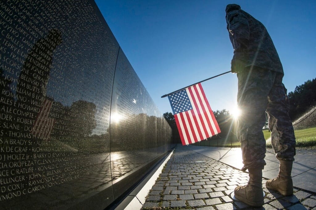 A U.S. Army Reserve soldier reads some of the 58,307 names etched into "The Wall" of the Vietnam Veterans Memorial in Washington