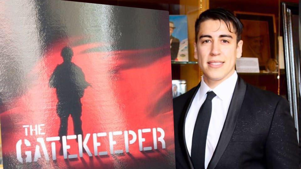 Jordan Michael Martinez poses next to a poster from his film, "The Gatekeeper"