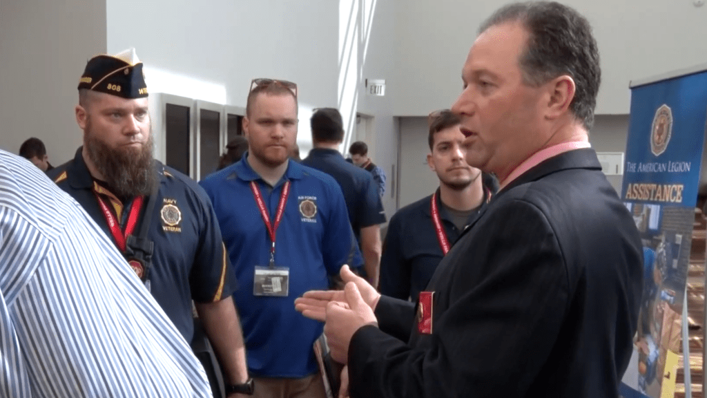 American Legion National Judge Advocate Kevin Bartlett speaks with legionnaires and other veterans