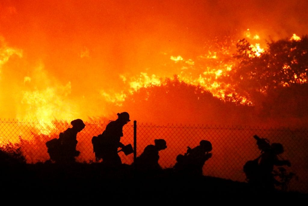 FIGHTING THE FLAMES Firefighters battle the Saddleridge Fire, in Southern California, on October 11. DAVID SWANSON—AP PHOTO