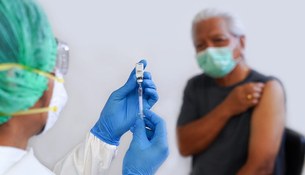 close up of doctor preparing a syringe for a patient