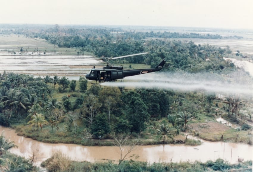 Agent Orange is sprayed by a U.S. Military helicopter during the Vietnam War.