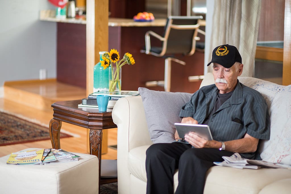 A Vietnam veteran uses a tablet computer for VA telehealth services