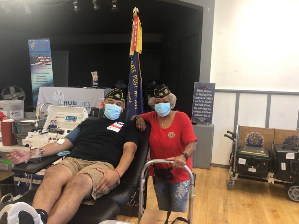 Aaron Thum, left, 1st vice commander of the South Gate Post 335 gives blood during an event at his post on Thursday, May 27, 2021. He is joined by Patricia Kelly Jackson, commander of Jackie Robinson Post 252.