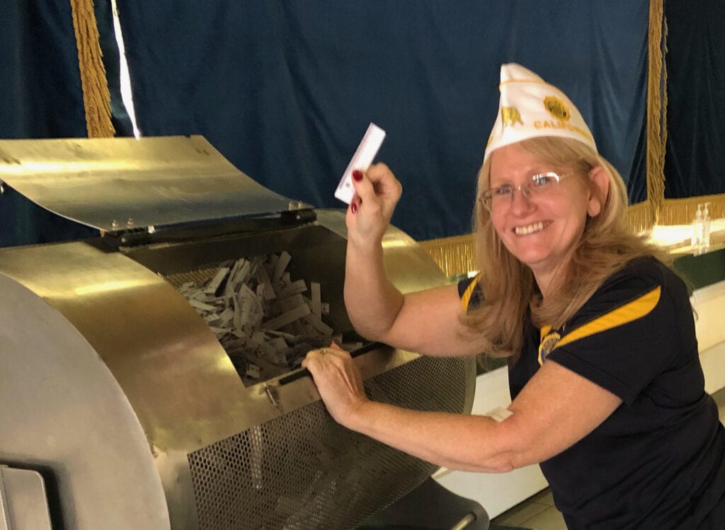 American Legion Department of California Adjutant Barbara Lombrano holds up a raffle ticket during the "America is Beautiful" Sweepstakes held on Tuesday, July 6, 2021.