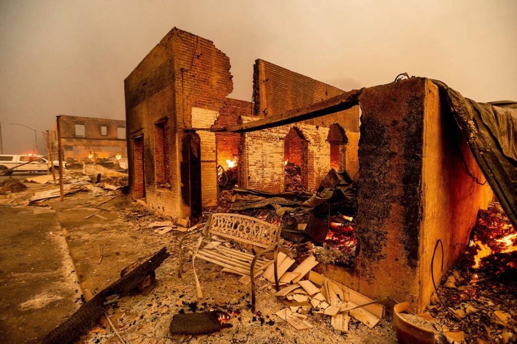 A bench stands outside a scorched building as the Dixie Fire tears through the Greenville community of Plumas County, Calif., on Wednesday, Aug. 4, 2021. The fire leveled multiple historic buildings and dozens of homes in central Greenville. (AP Photo/Noah Berger) Noah Berger AP