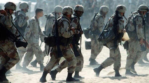 US troops marching forward on Kuwaiti soil during the Persian Gulf War