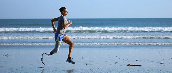 disabled veteran with prosthetic runs on beach