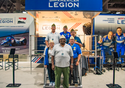 group gathered in front of an American Legion booth at the Long Beach Grand Prix