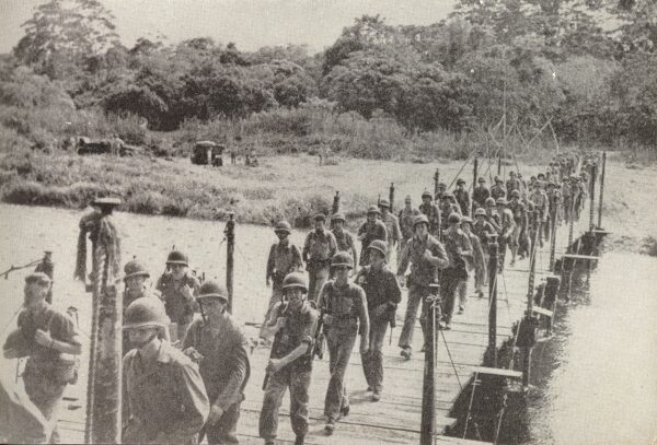US Marines cross a bridge somewhere during the Battle of Guadalcanal