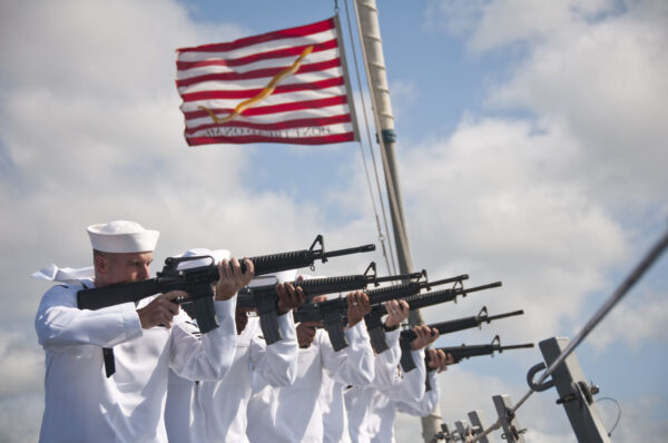 U.S. Sailors fire M16s during a 21-gun salute honoring lost sailors during the Battle of Okinawa