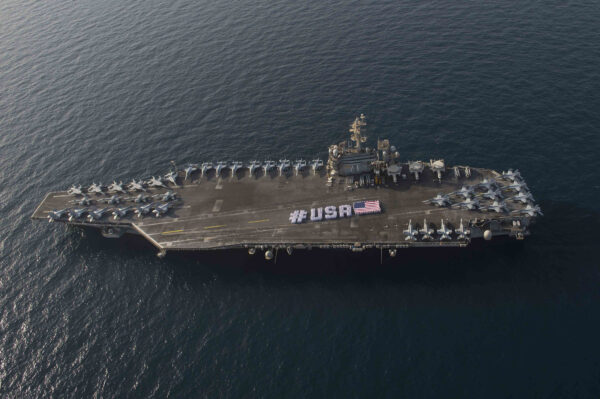 U.S. Navy sailors spell out "USA" on the top deck of the USS Theodore Roosevelt for Fourth of July celebrations.