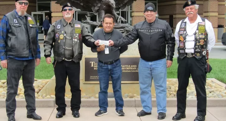 The American Legion Riders Chapter 105 and the SF Hogs present a check of money raised for the Palo Alto VA Suicide Prevention program