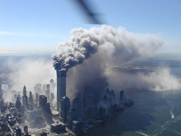 the photo captures the moment just after one of the Twin Towers fell during the September 11 Attacks. The remaining tower is billowing smoke and a massive cloud of dust is covering much of Manhattan.