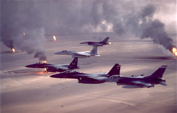 USAF F-15s and F-16s fly over burning oil fields in Kuwait during the Persian Gulf War