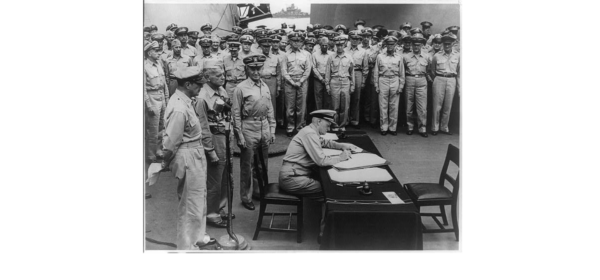 General McArthur and Admiral Nimitz lead a U.S. delegation on the deck of the USS Missouri to sign the Japanese Instrument of Surrender