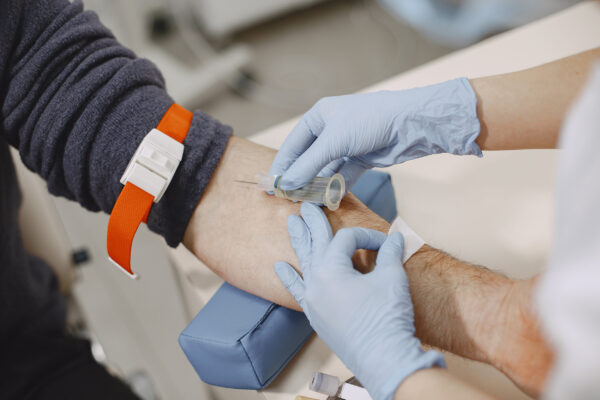 Photo of arm getting blood drawn by a nurse