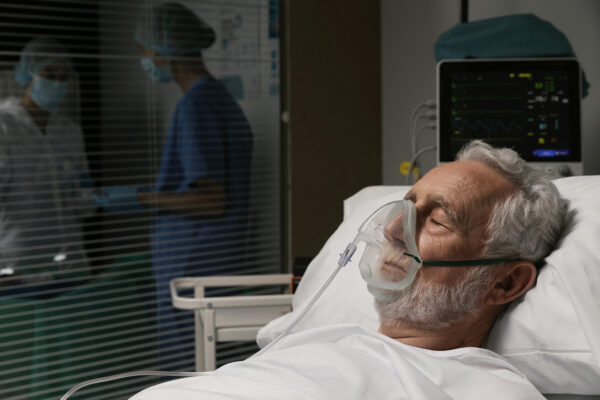 old-man-with-respirator-hospital-bed