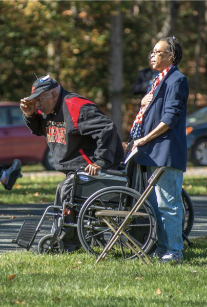 Retired and disabled U.S. Marine Veteran stands from his wheelchair to salute