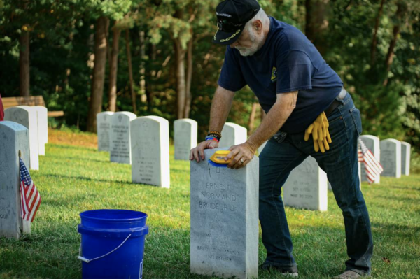 Air Force Veteran cleans headstones during Patriot Day