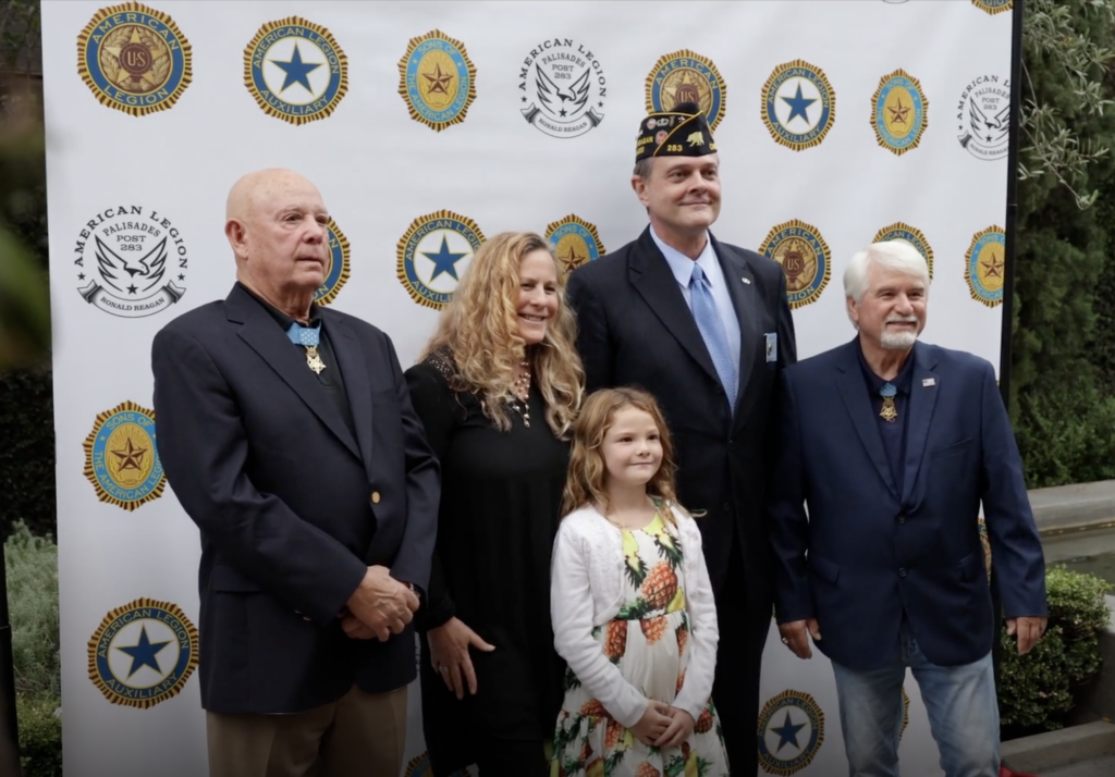 Medal of Honor recipients Gary Littrell (left) and James C. McCloughan (right) pose for a photo with American Legion Palisades Post 283 Commander Jim Cragg and his wife, Suzy, and daughter, Charlie, during the Evening of Honor event at the Luxe Hotel in Los Angeles in 2022.