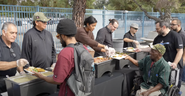 The Los Angeles Dodgers welcomed Veterans experiencing homelessness to Dodger Stadium for a Thanksgiving lunch, with the presence of Fernando Valenzuela, Joe Davis, and Kirsten Watson, who assisted in serving the meal.