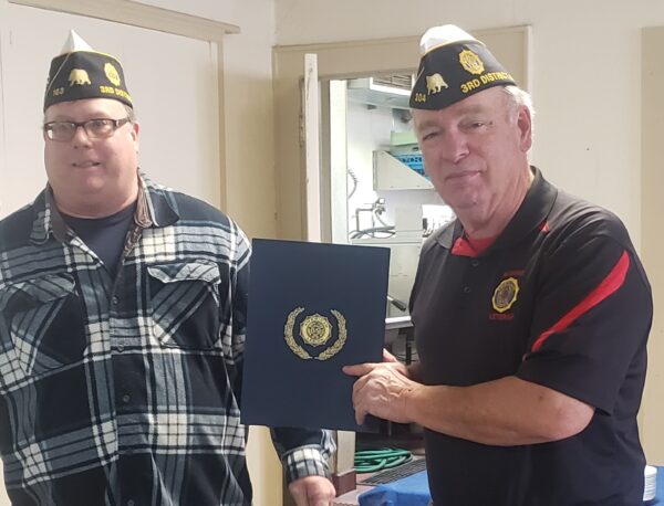 District 3 Commander Josh Bowers presents Robert Tyndall and Steve Soto (not pictured), representing Susanville Post 204, an award for achieving 120% membership